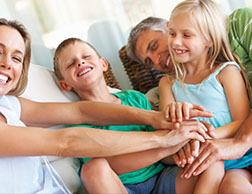 A family of dental patients satisfied that their Anchorage family dental clinic is committed to providing every member of your family with premium dentistry services
