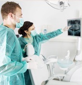 Dentists looking at one of the 99.9% of the extractions performed in-house and discussing a variety of options to make sure their patient is very comfortable