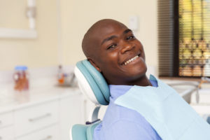 african man visiting dentist for consultation about a root canal.